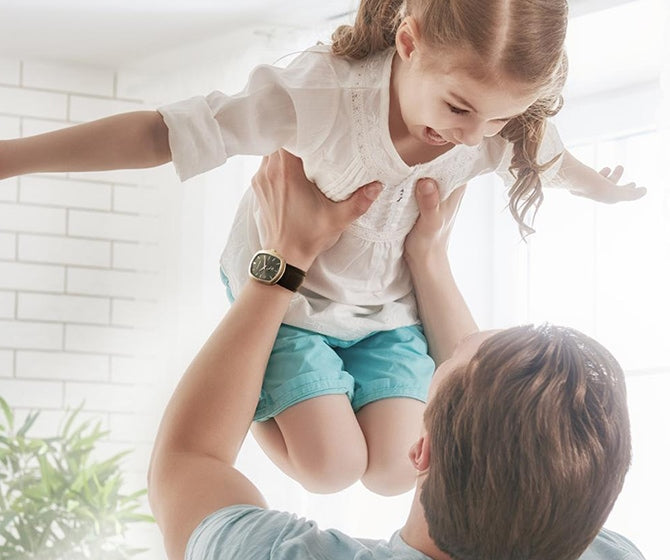 Man lifting his daughter in the air